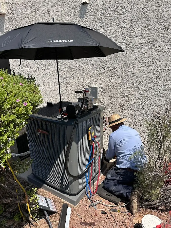 HVAC technician performing outdoor AC maintenance in Park