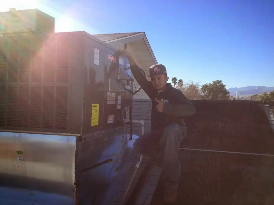 HVAC technician performing HVAC Inspection on a rooftop unit in Park
